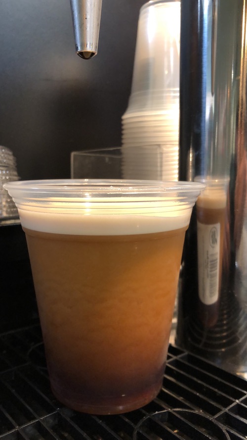 Close-up of a fresh-poured cup of Nitro Cold Brew at Honest Weight