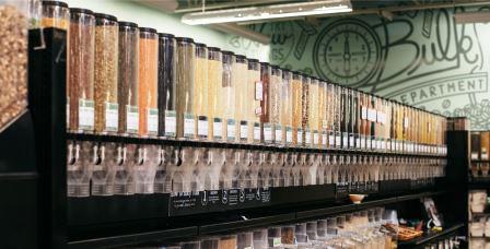 Bulk canisters at Honest Weight with multicolored beans, grains, and legumes