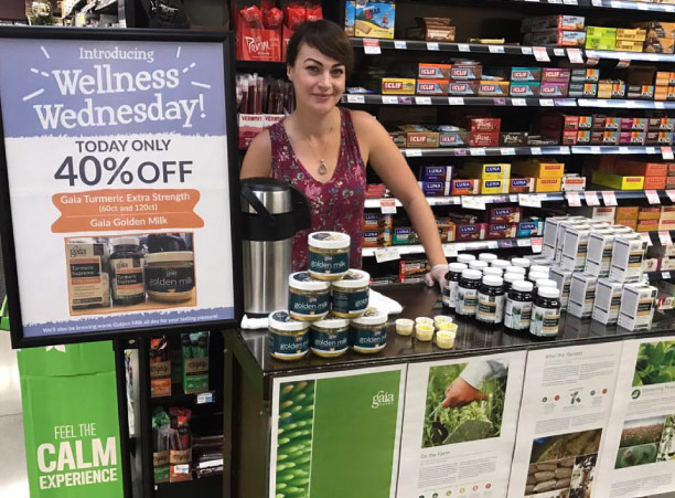 girl sampling Gaia Herbs brand Golden Milk at Honest Weight Food Co-op