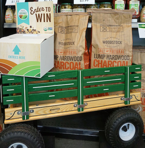 wooden wagon with two bags of Woodstock charcoal and box for raffle tickets